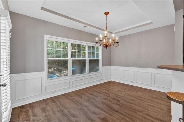 4349 Kousa Rd Unit 4, Austell, GA 30106 - unfurnished dining area featuring a raised ceiling, a chandelier, wainscoting, dark wood-style flooring, and a decorative wall