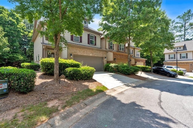 4349 Kousa Rd Unit 4, Austell, GA 30106 - view of property with brick siding, a garage, and driveway