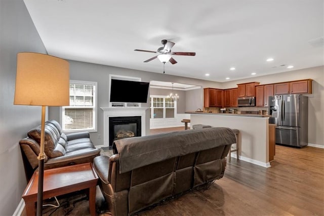 4349 Kousa Rd Unit 4, Austell, GA 30106 - living area featuring ceiling fan, recessed lighting, wood finished floors, a glass covered fireplace, and a chandelier