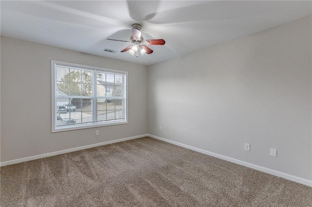 empty room with ceiling fan and carpet floors