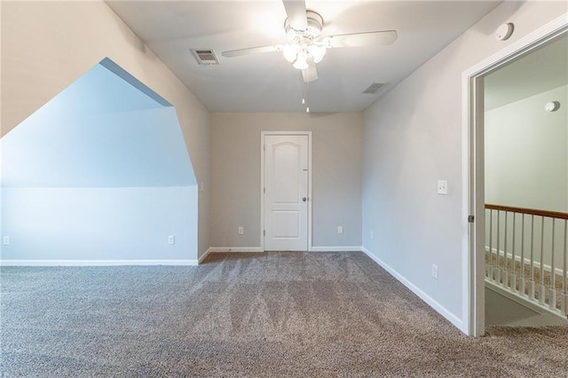 bonus room with ceiling fan and carpet floors