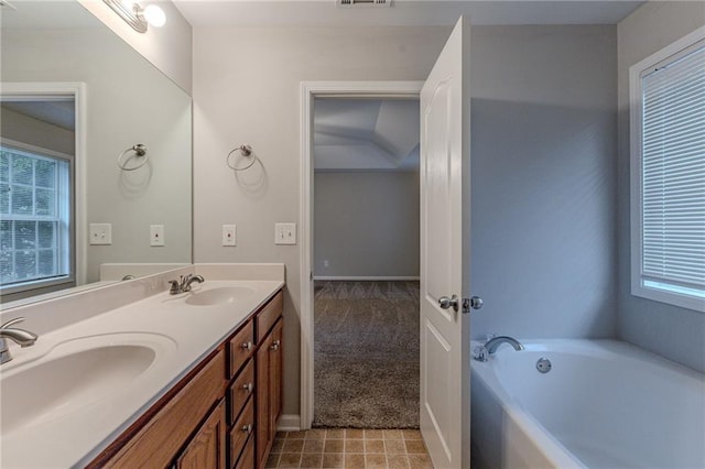 bathroom with vanity and a tub to relax in