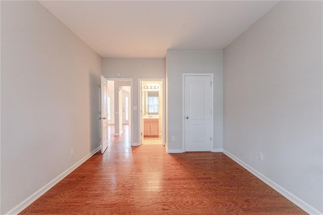 spare room with wood-type flooring