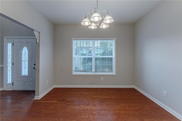 entryway featuring dark hardwood / wood-style flooring and a notable chandelier