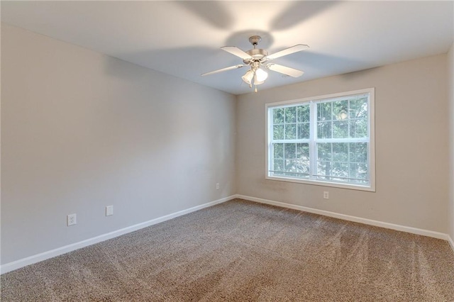 empty room with ceiling fan and carpet floors