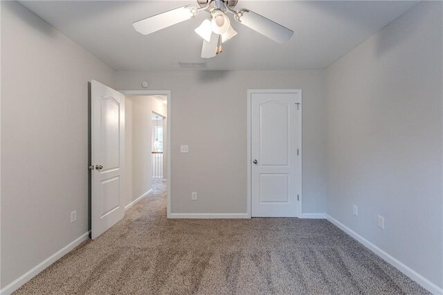 unfurnished bedroom featuring ceiling fan and carpet