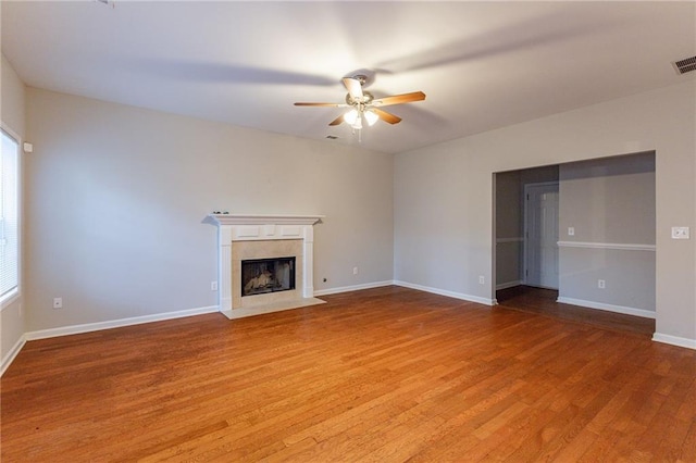 unfurnished living room featuring ceiling fan and wood-type flooring