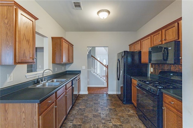 kitchen featuring backsplash, sink, and black appliances