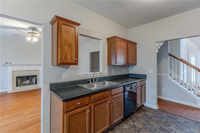 kitchen featuring ceiling fan, black dishwasher, dark hardwood / wood-style floors, and sink