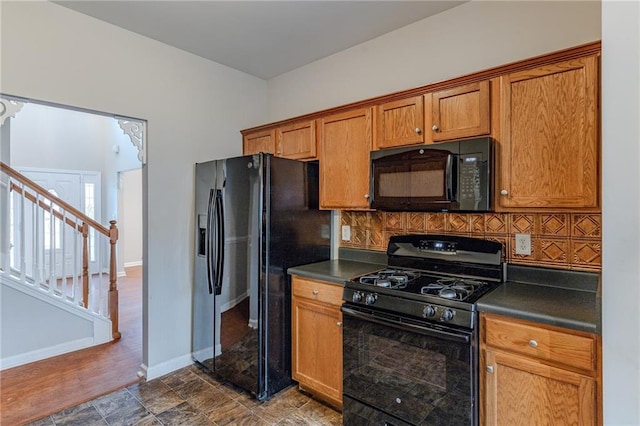 kitchen with decorative backsplash and black appliances