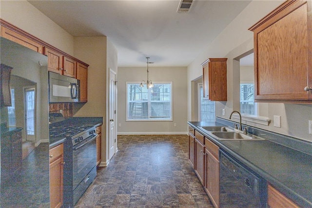 kitchen featuring black appliances, sink, hanging light fixtures, and a chandelier