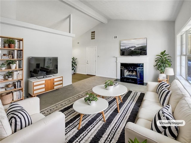 living room featuring a fireplace and vaulted ceiling with beams