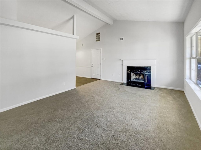 unfurnished living room featuring vaulted ceiling with beams and dark carpet