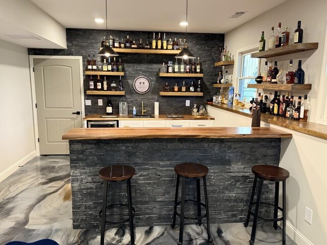 410 Spring Lake Hls, Canton, GA 30114 - bar with wet bar, hanging light fixtures, marble finish floor, baseboards, and visible vents