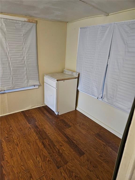 unfurnished room with hardwood / wood-style flooring