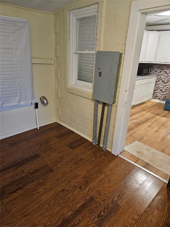 spare room featuring hardwood / wood-style flooring and electric panel