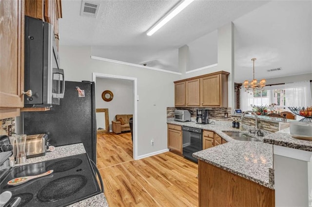 1164 Otis Dr, Bethlehem, GA 30620 - kitchen featuring black dishwasher, a peninsula, a chandelier, light wood-type flooring, and light stone countertops