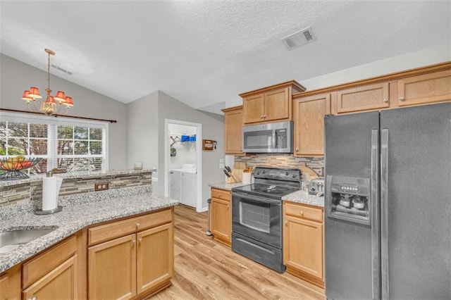 1164 Otis Dr, Bethlehem, GA 30620 - kitchen featuring refrigerator with ice dispenser, stainless steel microwave, black range with electric cooktop, washer and dryer, and lofted ceiling