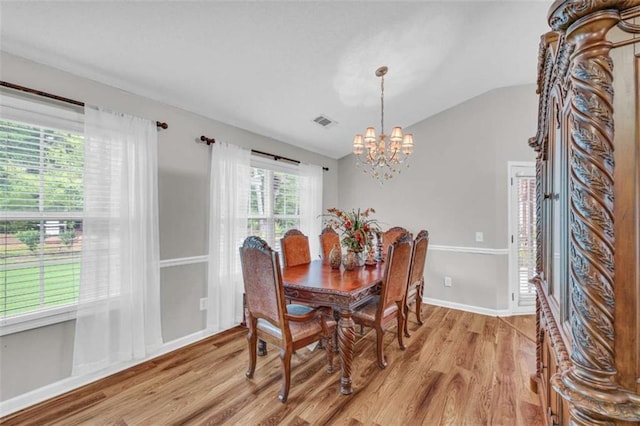 1164 Otis Dr, Bethlehem, GA 30620 - dining room with lofted ceiling, light wood finished floors, and a chandelier