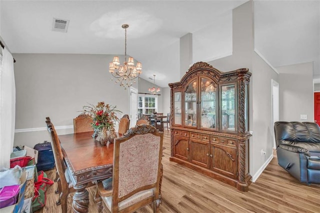 1164 Otis Dr, Bethlehem, GA 30620 - dining room featuring light wood-style floors, a chandelier, and lofted ceiling