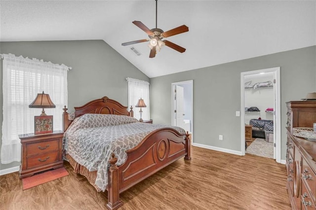 1164 Otis Dr, Bethlehem, GA 30620 - bedroom with lofted ceiling, a walk in closet, light wood-style flooring, a closet, and ensuite bathroom