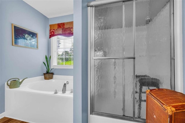 1164 Otis Dr, Bethlehem, GA 30620 - bathroom with a bath, a shower stall, and wood finished floors