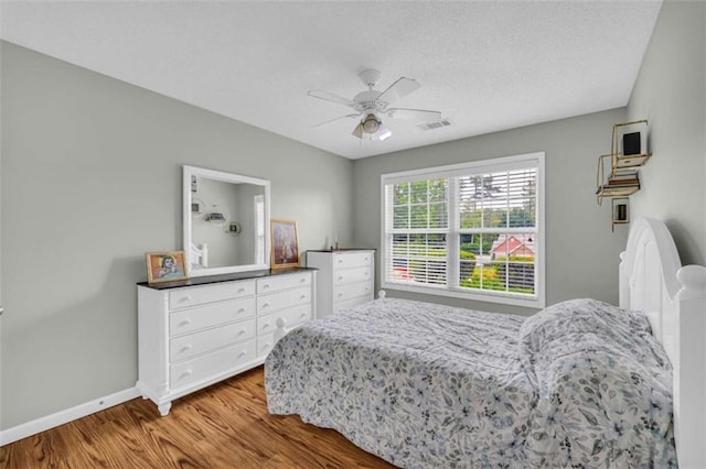 1164 Otis Dr, Bethlehem, GA 30620 - bedroom featuring wood finished floors, ceiling fan, and a textured ceiling
