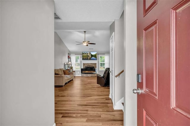 1164 Otis Dr, Bethlehem, GA 30620 - entrance foyer with ceiling fan, wood finished floors, and a fireplace