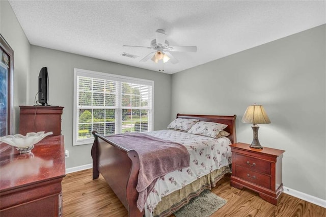 1164 Otis Dr, Bethlehem, GA 30620 - bedroom with wood finished floors, a textured ceiling, and a ceiling fan