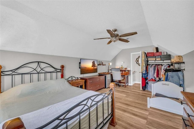 1164 Otis Dr, Bethlehem, GA 30620 - bedroom with a textured ceiling, light wood-style floors, lofted ceiling, and a ceiling fan