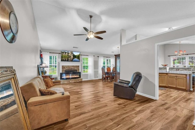 1164 Otis Dr, Bethlehem, GA 30620 - living area featuring a fireplace, light wood-style floors, a ceiling fan, and vaulted ceiling