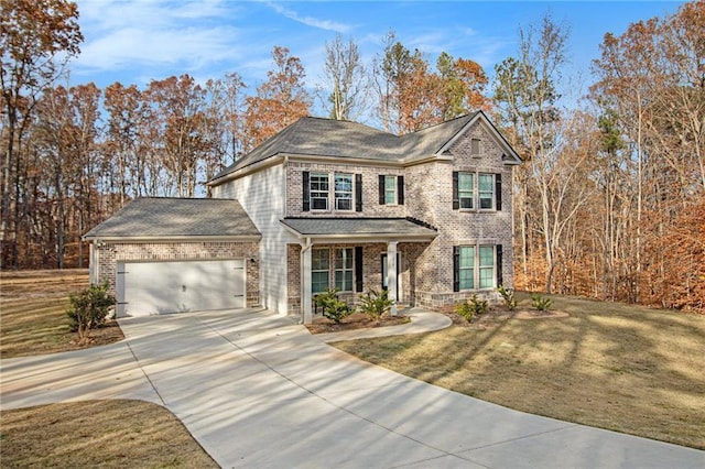 view of front of home featuring a front yard and a garage