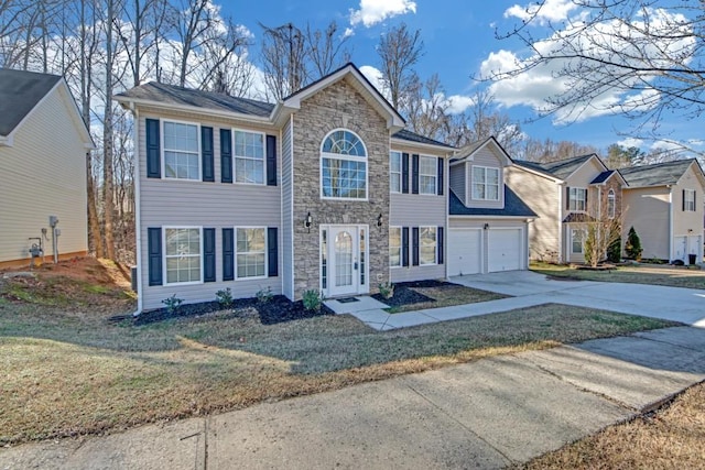 view of front of property featuring a garage and a front lawn