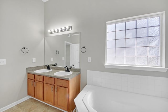 bathroom featuring tile patterned floors, vanity, and a bathing tub