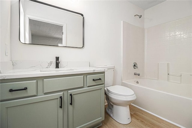 full bath with shower / washtub combination, vanity, toilet, and wood finished floors