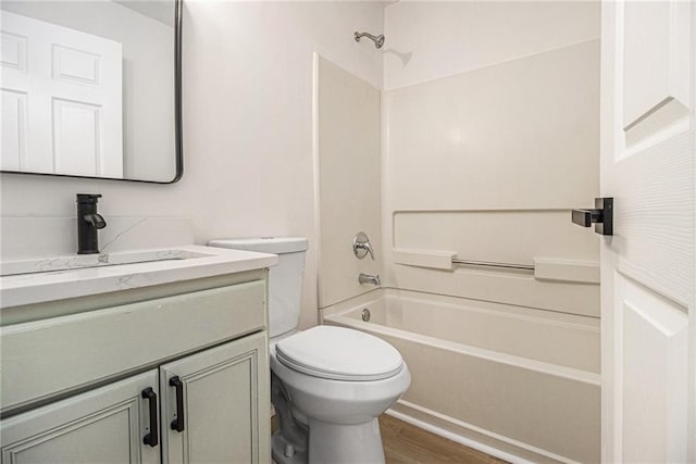 full bathroom with wood finished floors, vanity, toilet, and shower / bathtub combination