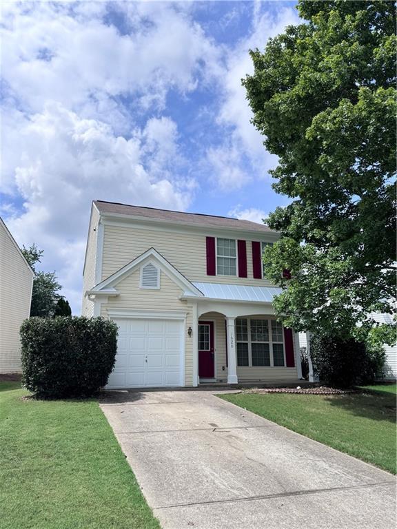 view of front of home with a garage and a front lawn