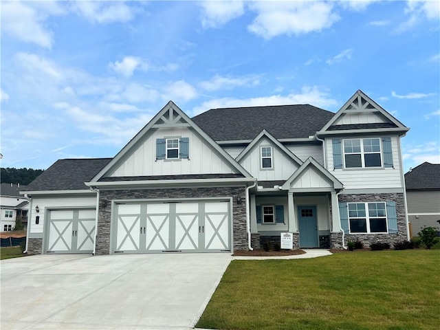 craftsman house featuring a garage, central AC unit, and a front yard