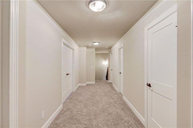 hallway with light colored carpet