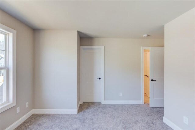 empty room featuring light colored carpet