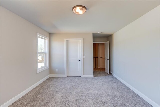 unfurnished bedroom with light colored carpet