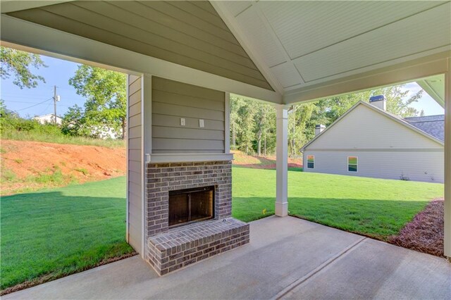 view of patio with an outdoor brick fireplace