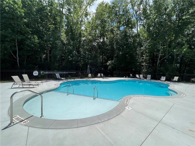 view of pool featuring a patio