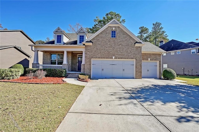 view of front of home with a porch, a garage, and a front lawn