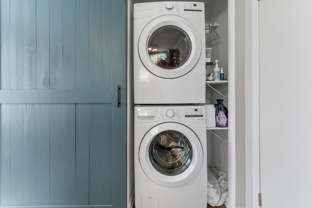 laundry room featuring stacked washer / drying machine