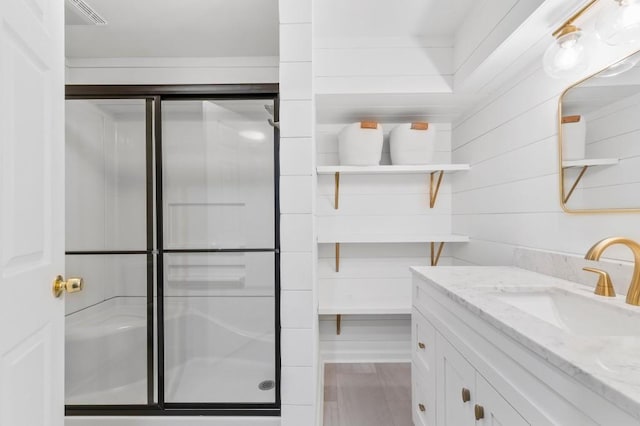 bathroom with walk in shower and vanity