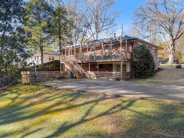 rear view of house with a lawn