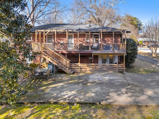 rear view of house with a porch, a patio, and french doors