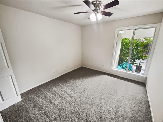 empty room featuring ceiling fan and carpet