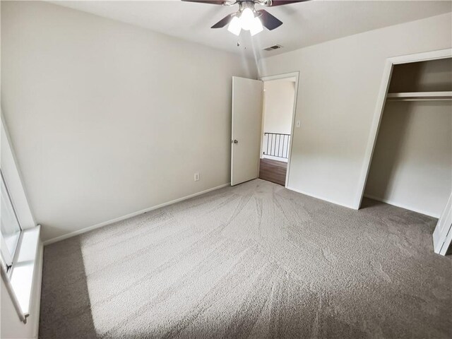 unfurnished bedroom featuring light carpet, ceiling fan, and a closet